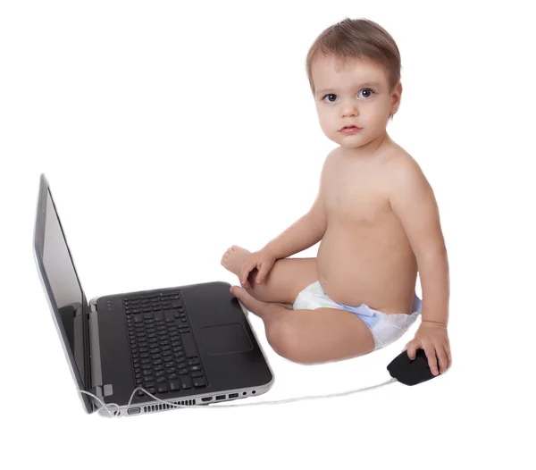 Cute baby playing with a laptop computer isolated on white — Stock Photo, Image