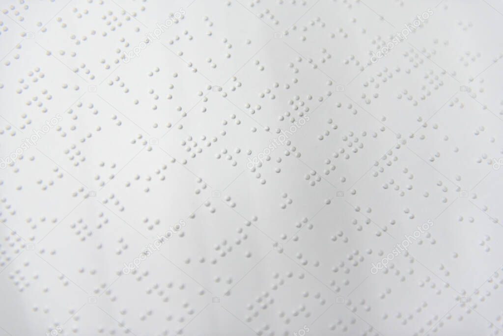 A fragment of text in Louis Braille printed on a standard sheet of paper using special printing equipment.