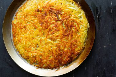 Bir tava altın isviçre rosti kızarmış patatesli krep.