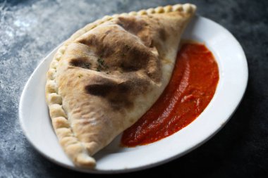 close up of italian calzone folded pizza                     