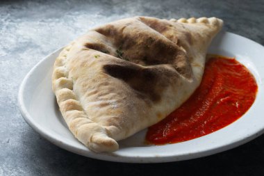 close up of italian calzone folded pizza                     