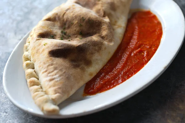 close up of italian calzone folded pizza                     