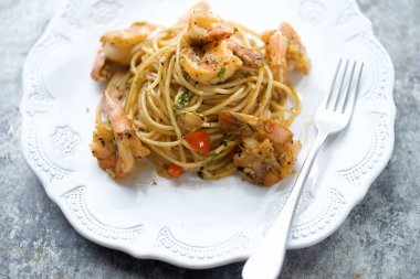  close up of italian spicy garlic shrimp pasta                              