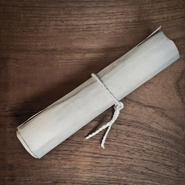 Ancient scroll on wooden table, top view