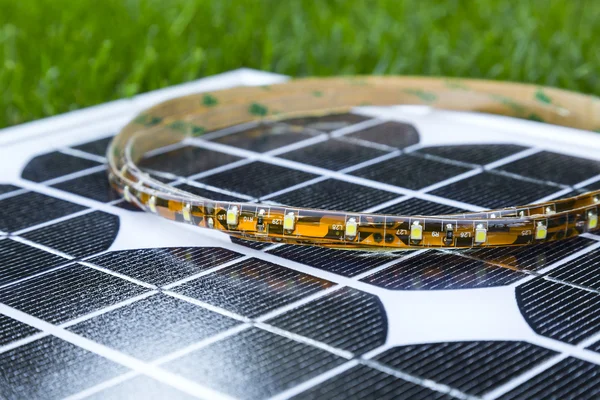 Curled LED strip on photovoltaic solar panel — Stock Photo, Image