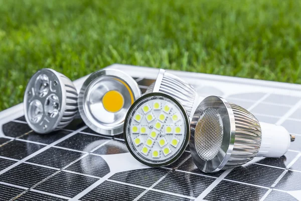 Verschiedene gu10 LED-Lampen auf Photovoltaik im Gras — Stockfoto