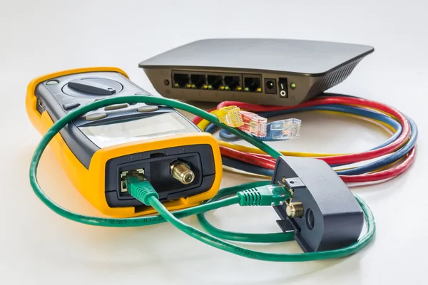 Network tester and small switch with various color RJ45 cables c — Stock Photo, Image