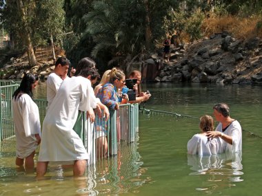 Israel Ablution in holy waters of the Jordan River clipart
