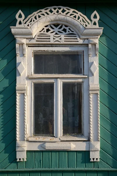 Window with carved platbands — Stock Photo, Image