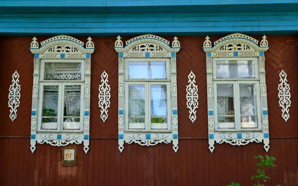 Three windows with carved platbands — Stock Photo, Image