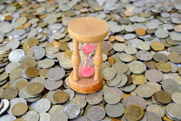 Hourglasses stand on the Russian metallic currency. Time is mone