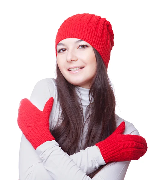 Жінка в червоній шапці обіймає себе Ліцензійні Стокові Зображення