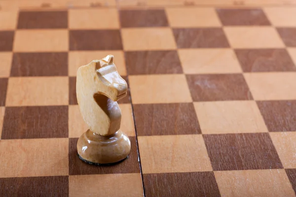 Pièce d'échecs chevalier sur un plateau — Photo