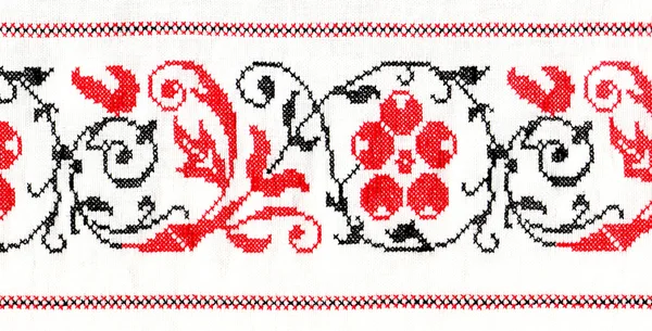 Red ornament stitched on linen background — Stock Photo, Image