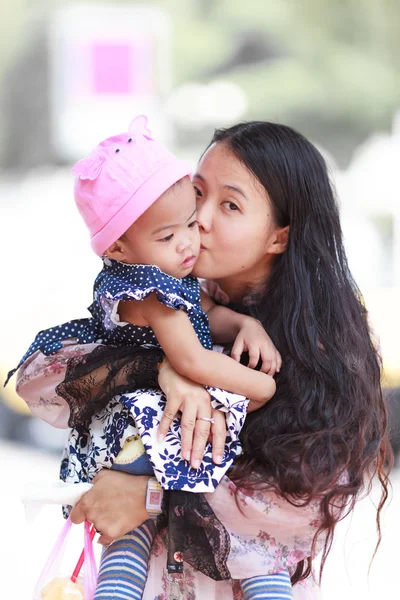 Mujer asiática sosteniendo y besando bebé — Foto de Stock