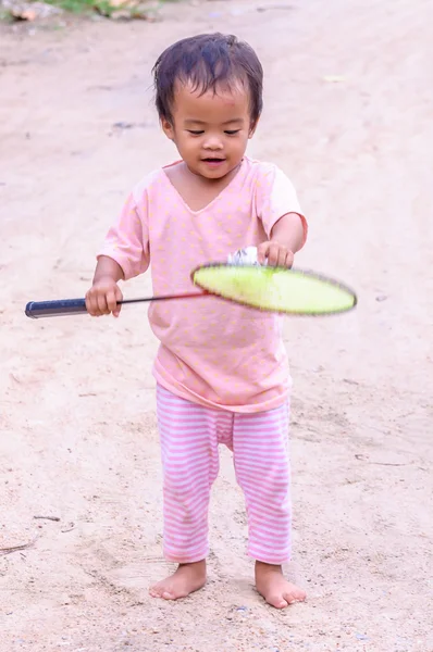 Baby girl playing with racket — Stock Photo, Image