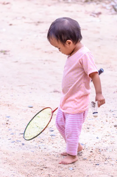 Baby girl playing with racket — Stock Photo, Image