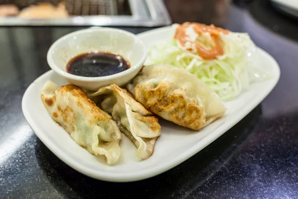 Fried gyoza on white dish — Stock Photo, Image