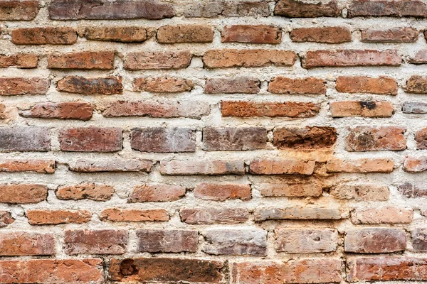 Old orange cracked brick wall — Stock Photo, Image