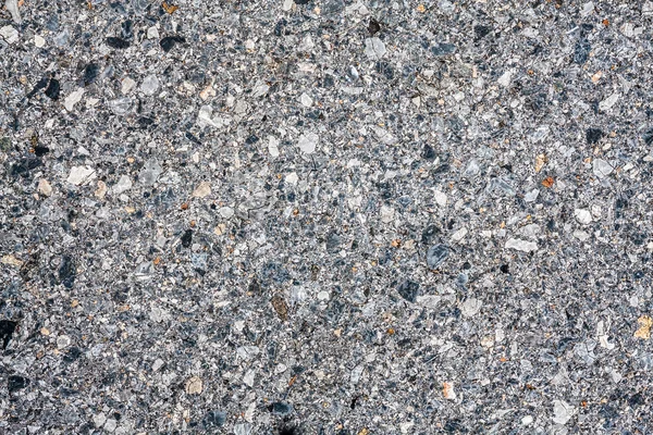 Dark asphalt with gravel texture — Stock Photo, Image