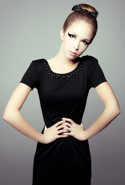 Portrait of a girl in a little black dress.