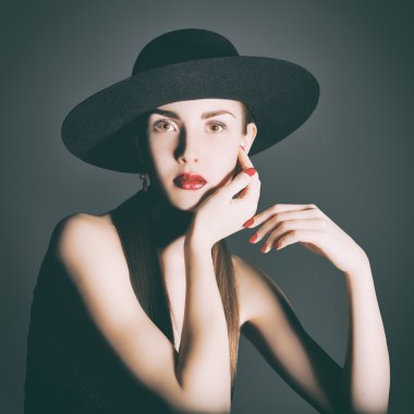 Portrait of young woman in a black hat. clipart