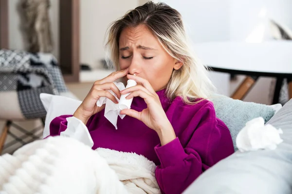 Woman is having flu and she is using nasal spray to help herself. Woman using nasal spray. Nasal spray to help a cold. Sick with a rhinitis woman dripping nose. Woman applies nasal spray