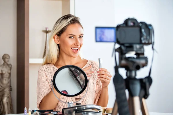 美しい若い女性ブロガーは ソーシャルメディアの概念に自宅のオンラインインフルエンサーで化粧品とVlogビデオを記録します — ストック写真