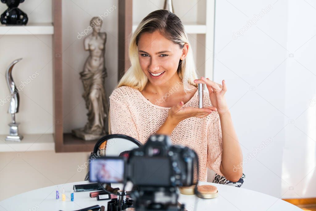 Beautiful young female blogger recording vlog video with makeup cosmetic at home online influencer on social media concept.live streaming viral
