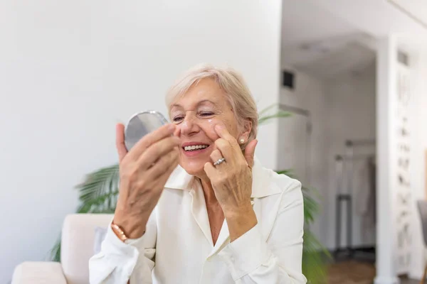 Senior Woman Looking Mirror Applying Wrinkles Face Cream Mature Adult — Stockfoto