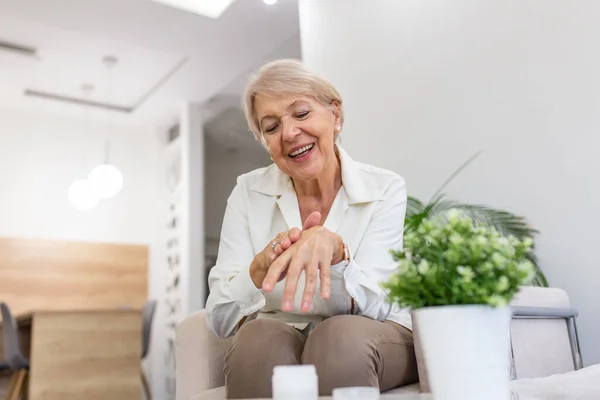 Smiling Senior Woman Applying Aging Hand Lotion Happy Mature Woman — Stockfoto