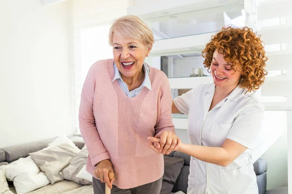 Smiling Nurse Helping Senior Lady Walk Nursing Home Portrait Happy — Stockfoto