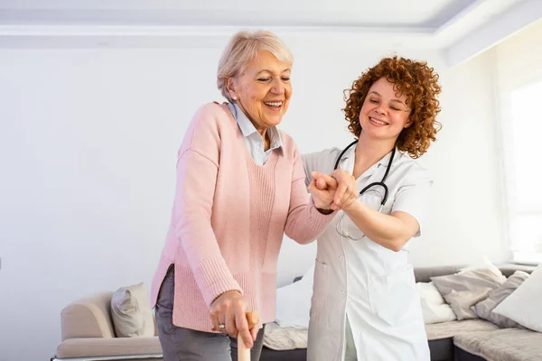 Smiling Nurse Helping Senior Lady Walk Nursing Home Portrait Happy — Foto Stock