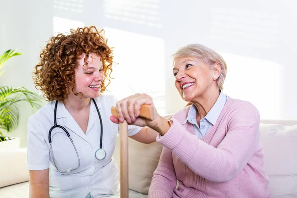 Young Caregiver Senior Woman Laughing Together While Sitting Sofa Senior — Foto de Stock