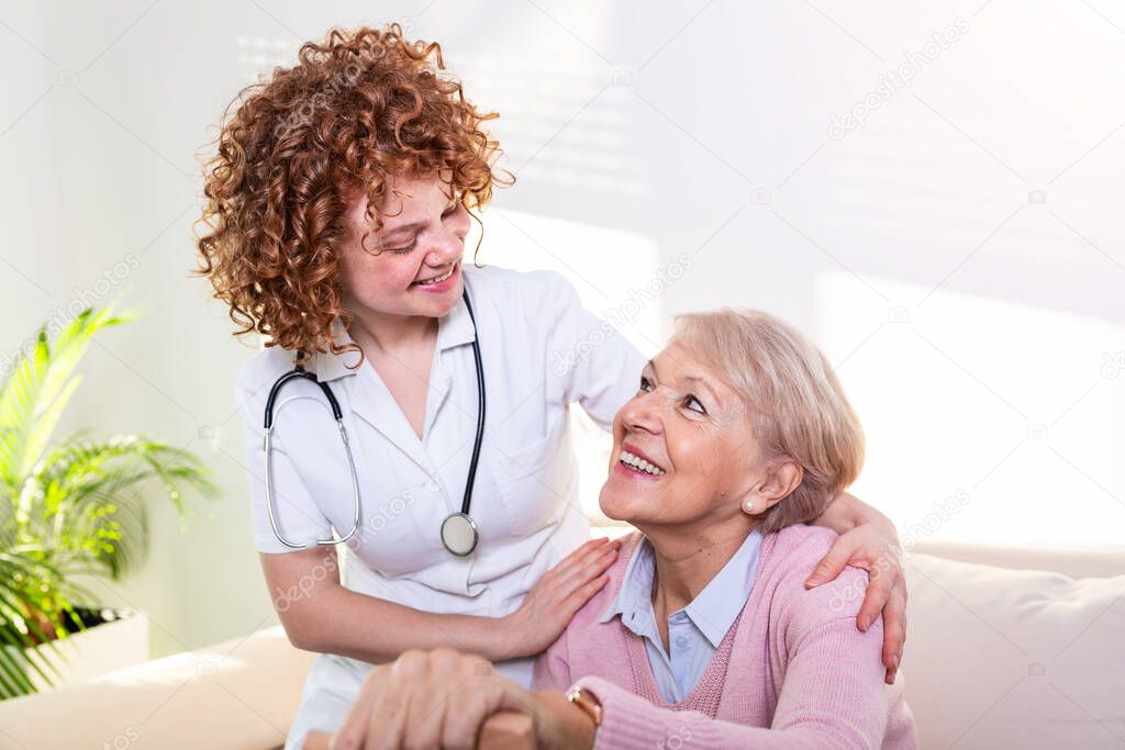 Close positive relationship between senior patient and caregiver. Happy senior woman talking to a friendly caregiver. Young pretty caregiver and older happy woman