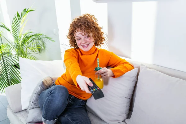 Young Woman Curly Red Hair Holding Remote Control Watching Changing — Stockfoto