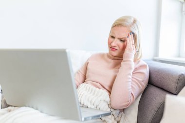 Bitkin hissediyorum. Hüsrana uğramış genç bir kadın evinde çalışırken bitkin görünüyor. Serbest çalışan biri baş ağrısı çekiyor.