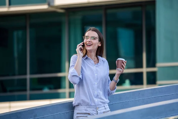 Attractive Businesswoman Drinking Coffee Using Mobile Phone While Standing Window — Stockfoto