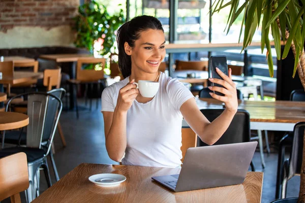 Portrait Playful Young Girl Taking Selfie Mobile Phone While Sitting — 스톡 사진