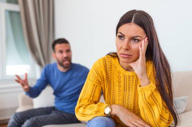 Young couple in conflict, man and woman fight. Furious couple arguing while having problems in their relationship. Young couple arguing while having problems in their relationship.