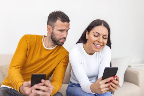 Young Couple Using Smartphones Home Jealous Boyfriend Spying His Girlfriend — Stockfoto