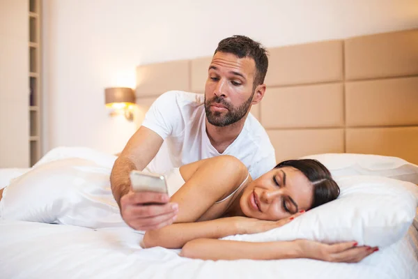 Jealous Husband Spying Phone His Partner While She Sleeping Bed — Stockfoto