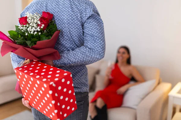 Young Handsome Man Holding Gift Flowers His Back Surprise His — kuvapankkivalokuva