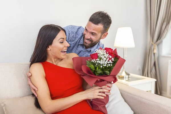 Affectionate Young Man Giving His Beautiful Young Wife Bouquet Red — kuvapankkivalokuva