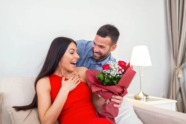 Excited Young Woman Receiving Unexpected Bouquet Red Roses Husband Home — 스톡 사진