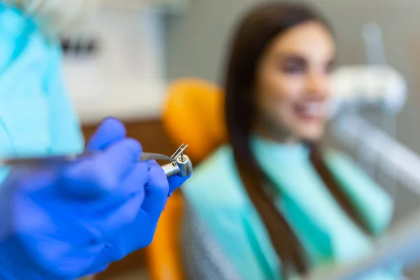 Woman at the dentist\'s chair during a dental procedure. Overview of dental caries prevention. Healthy teeth concept.