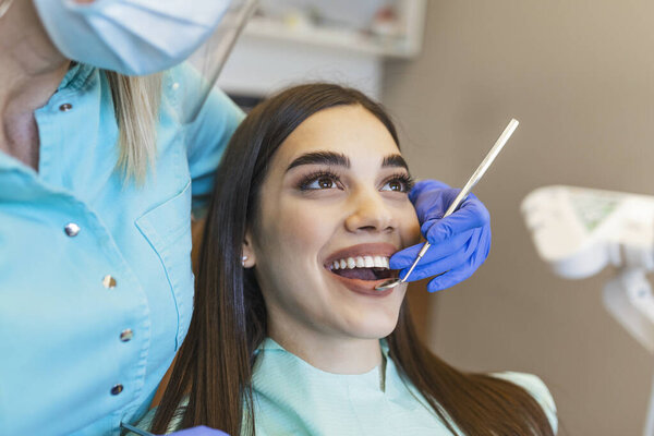 Portrait of female patient having treatment at dentist.Dentist examining a patient's teeth in dentist office.