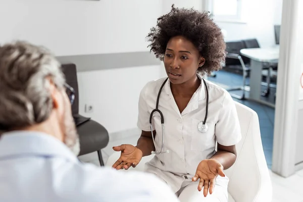 Black Female Doctor Senior Man Communicating Waiting Room Hospital Medicine — Stok fotoğraf