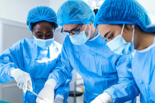 A surgeon\'s team in uniform performs an operation on a patient at a cardiac surgery clinic. Modern medicine, a professional team of surgeons, health.