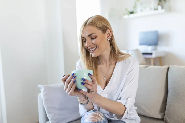Shot Young Woman Relaxing Her Sofa Cup Coffee Having Coffee — Foto de Stock